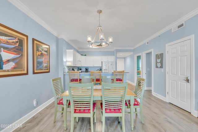 17545 Front Beach Rd Unit 2004, Panama City Beach, FL 32413 - dining space with a chandelier, light wood-style flooring, ornamental molding, and baseboards
