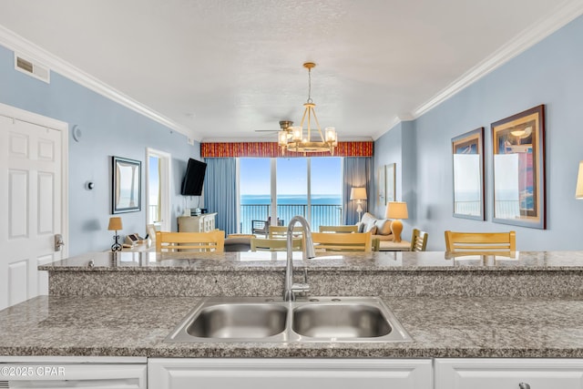 17545 Front Beach Rd Unit 2004, Panama City Beach, FL 32413 - kitchen featuring a sink, a chandelier, white cabinets, ornamental molding, and open floor plan