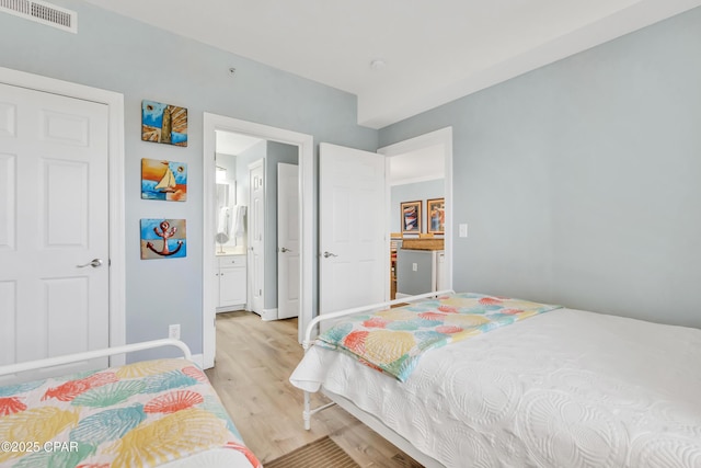 17545 Front Beach Rd Unit 2004, Panama City Beach, FL 32413 - bedroom with light wood finished floors, baseboards, and ensuite bathroom
