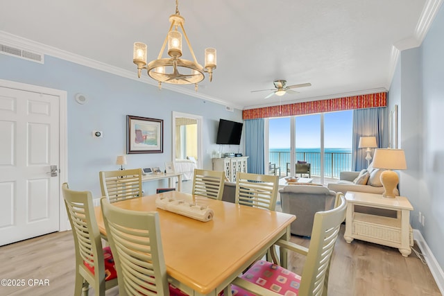 17545 Front Beach Rd Unit 2004, Panama City Beach, FL 32413 - dining space with ornamental molding, light wood-type flooring, ceiling fan, a chandelier, and baseboards