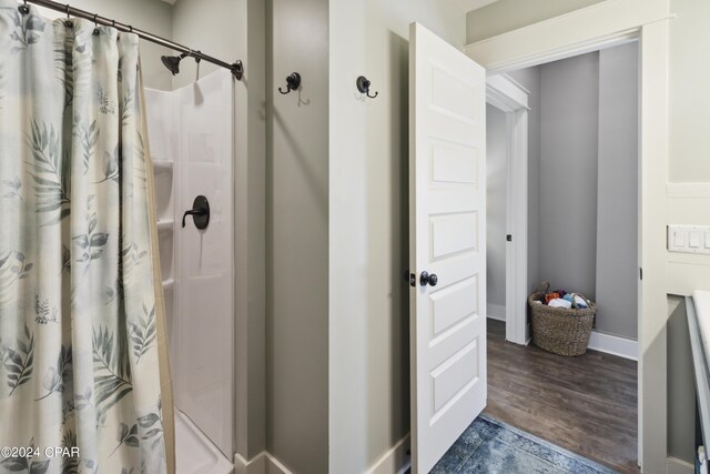 290 Rudys Blaze, Wewahitchka, FL 32465 - bathroom featuring a shower with shower curtain and wood finished floors