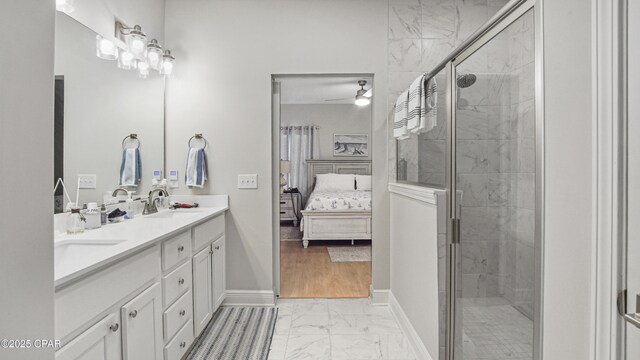 113 Mosaic Dr, Port St Joe, FL 32456 - ensuite bathroom featuring marble look tile flooring, double vanity, a stall shower, and ceiling fan