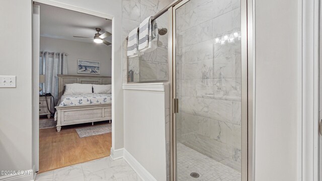 113 Mosaic Dr, Port St Joe, FL 32456 - ensuite bathroom with marble finish flooring, a ceiling fan, a shower stall, and baseboards