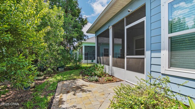 113 Mosaic Dr, Port St Joe, FL 32456 - view of side of home featuring a sunroom and a patio
