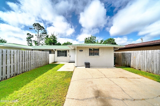 823 Bradley Cir, Lynn Haven, FL 32444 - single story home featuring stucco siding, metal roof, and a patio