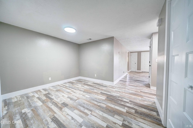 823 Bradley Cir, Lynn Haven, FL 32444 - spare room featuring light wood finished floors, baseboards, and a textured ceiling