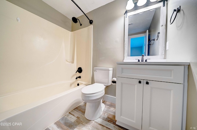 823 Bradley Cir, Lynn Haven, FL 32444 - bathroom with toilet,  shower combination, vanity, wood finished floors, and baseboards