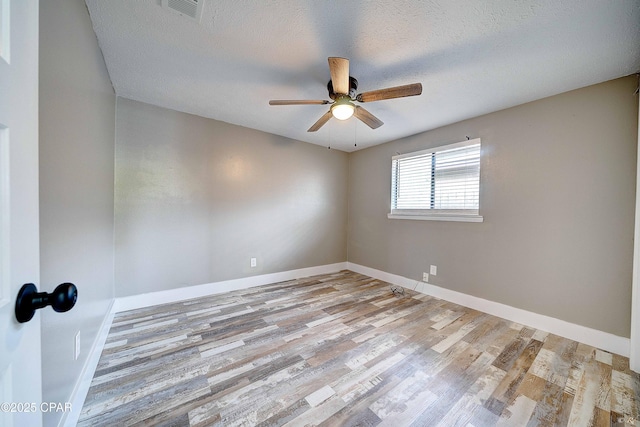 823 Bradley Cir, Lynn Haven, FL 32444 - spare room featuring a ceiling fan, wood finished floors, baseboards, and a textured ceiling