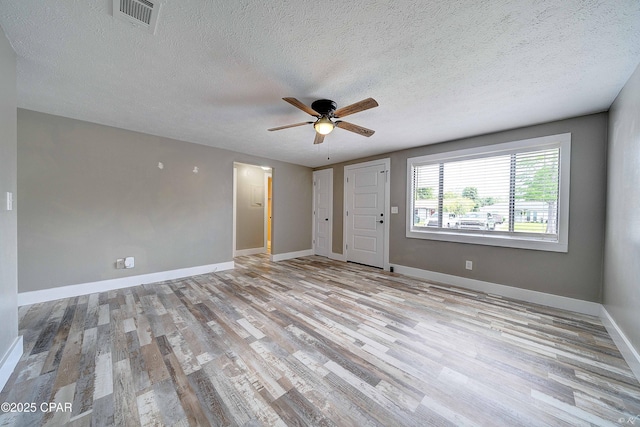 823 Bradley Cir, Lynn Haven, FL 32444 - unfurnished room with a textured ceiling, wood finished floors, a ceiling fan, and baseboards