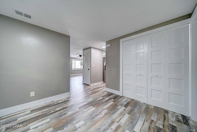 823 Bradley Cir, Lynn Haven, FL 32444 - unfurnished living room with baseboards and wood finished floors
