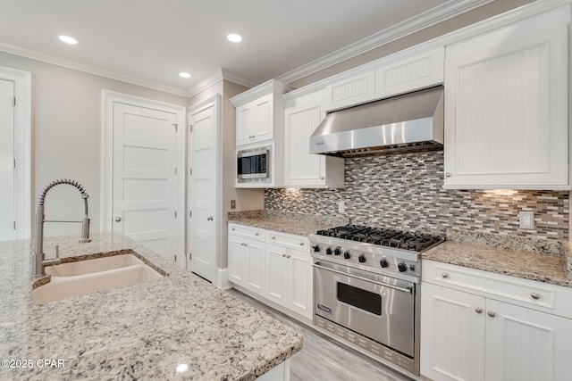 4134 Cobalt Cir Unit Ro14, Panama City Beach, FL 32408 - kitchen with stainless steel appliances, exhaust hood, a sink, ornamental molding, and white cabinets