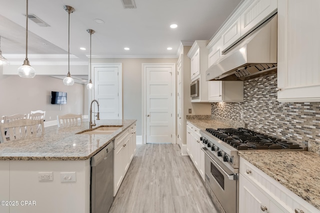 4134 Cobalt Cir Unit Ro14, Panama City Beach, FL 32408 - kitchen featuring stainless steel appliances, custom range hood, a sink, crown molding, and white cabinetry
