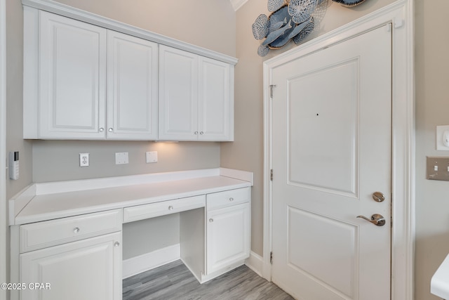 4134 Cobalt Cir Unit Ro14, Panama City Beach, FL 32408 - unfurnished office featuring built in desk, light wood finished floors, and baseboards