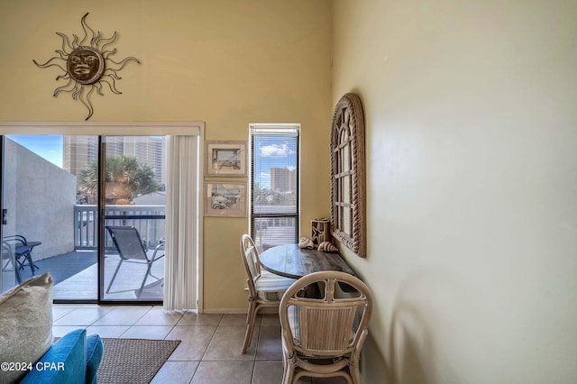 17614 Front Beach Rd Unit 17E, Panama City Beach, FL 32413 - dining space featuring light tile patterned flooring, a towering ceiling, and baseboards
