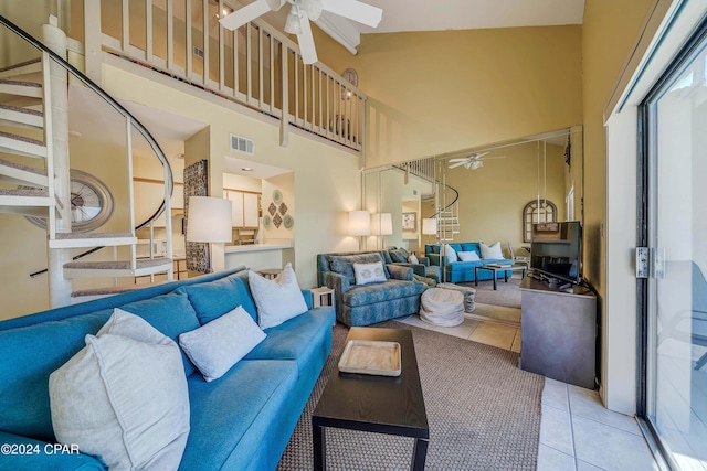 17614 Front Beach Rd Unit 17E, Panama City Beach, FL 32413 - living area featuring ceiling fan, a towering ceiling, light tile patterned floors, and stairs