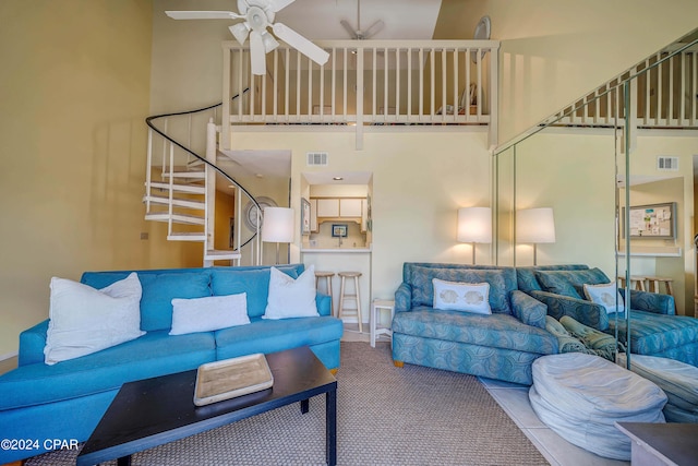 17614 Front Beach Rd Unit 17E, Panama City Beach, FL 32413 - living area featuring carpet floors, ceiling fan, a towering ceiling, and stairway