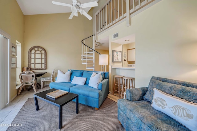 17614 Front Beach Rd Unit 17E, Panama City Beach, FL 32413 - living room with a towering ceiling, stairway, a ceiling fan, and light tile patterned floors