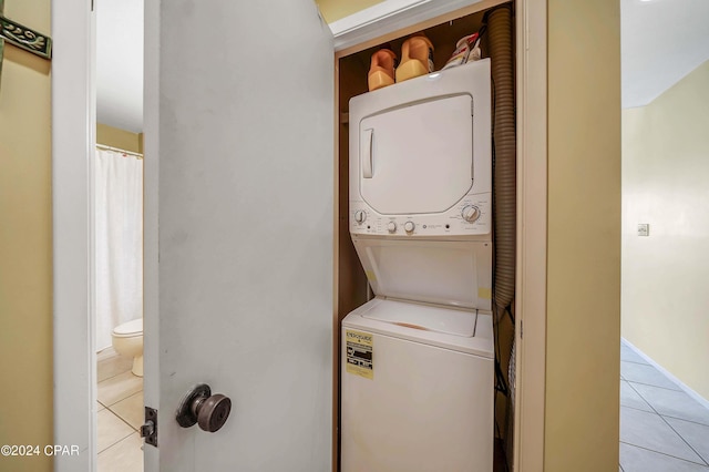 17614 Front Beach Rd Unit 17E, Panama City Beach, FL 32413 - washroom featuring stacked washer / drying machine and light tile patterned flooring