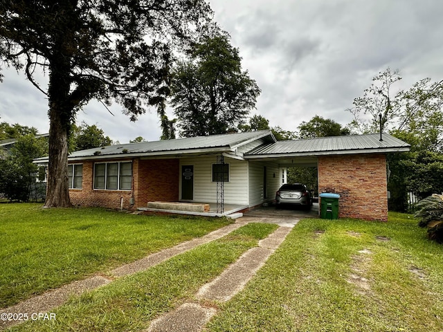 2958 Russ St, Marianna, FL 32446 - ranch-style house with driveway, a front yard, a carport, and metal roof