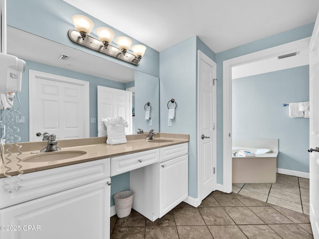 9450 S Thomas Dr Unit 1211, Panama City, FL 32408 - bathroom with double vanity, a garden tub, tile patterned flooring, and baseboards