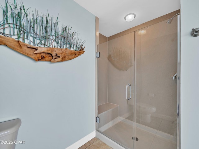 9450 S Thomas Dr Unit 1211, Panama City, FL 32408 - full bathroom featuring toilet, a stall shower, tile patterned floors, and baseboards