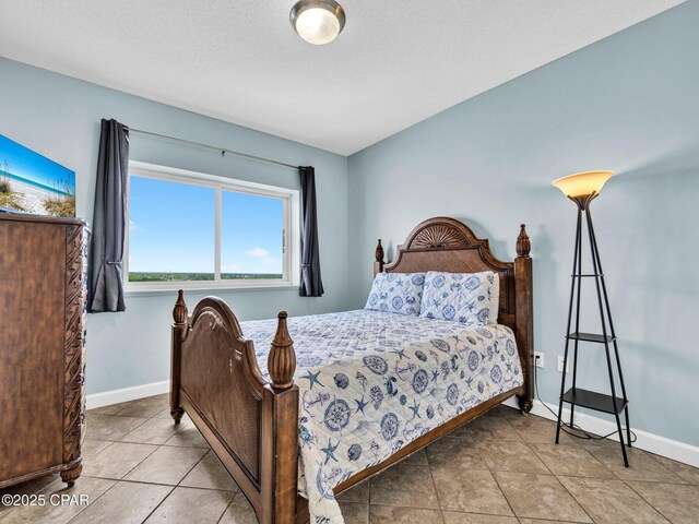 9450 S Thomas Dr Unit 1211, Panama City, FL 32408 - bedroom featuring baseboards and tile patterned floors