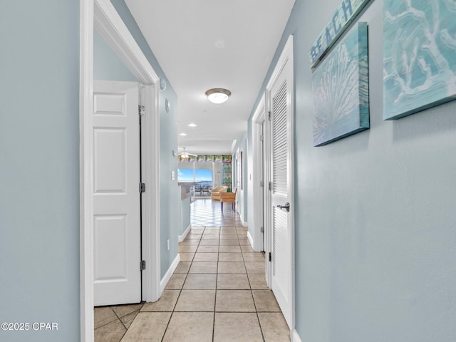 9450 S Thomas Dr Unit 1211, Panama City, FL 32408 - corridor with light tile patterned flooring and baseboards