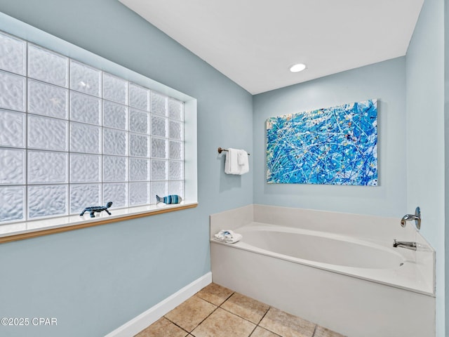 9450 S Thomas Dr Unit 1211, Panama City, FL 32408 - bathroom featuring a garden tub, baseboards, and tile patterned floors