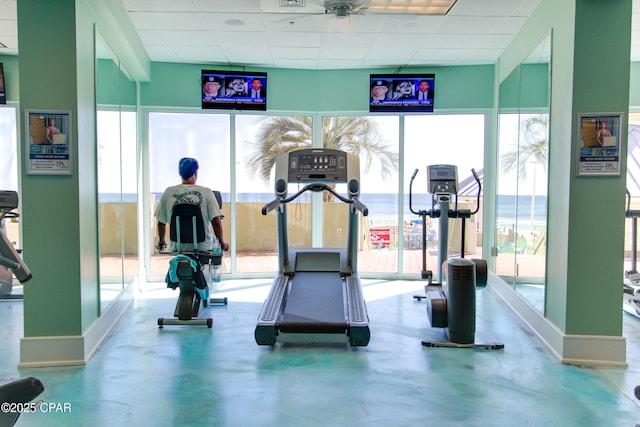 9450 S Thomas Dr Unit 1211, Panama City, FL 32408 - exercise room featuring a drop ceiling, healthy amount of natural light, and baseboards