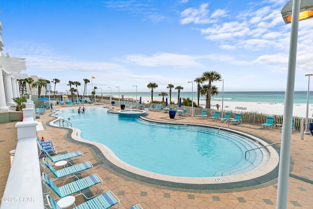 9450 S Thomas Dr Unit 1211, Panama City, FL 32408 - community pool with a hot tub, a water view, and a patio