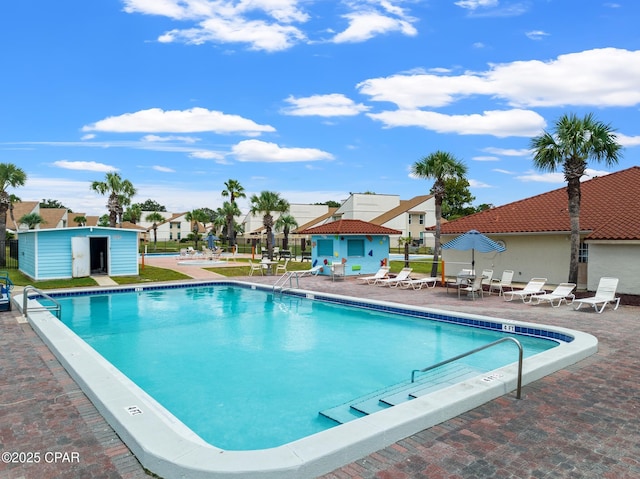 17462 Front Beach Rd, Panama City Beach, FL 32413 - community pool featuring an outdoor structure, a patio, and a residential view