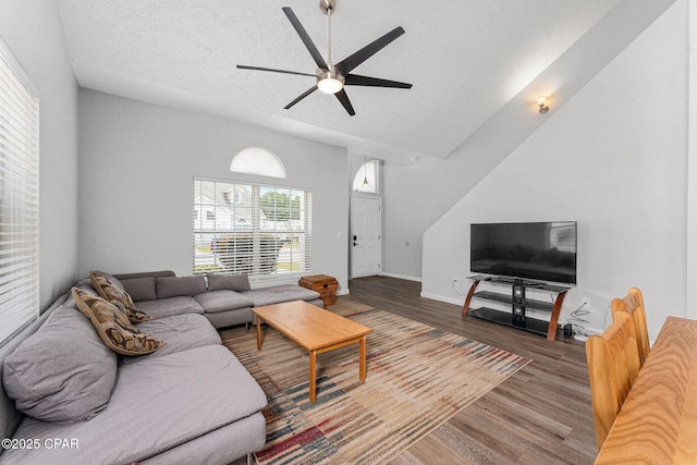 190 White Cap Way, Panama City Beach, FL 32407 - living room featuring ceiling fan, wood finished floors, a textured ceiling, baseboards, and lofted ceiling