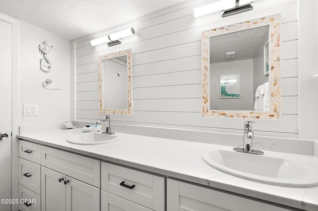 23223 Front Beach Rd Unit C1-502, Panama City Beach, FL 32413 - full bathroom with a textured ceiling, double vanity, and wooden walls