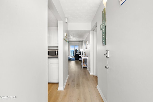 23223 Front Beach Rd Unit C1-502, Panama City Beach, FL 32413 - hallway with light wood-type flooring and baseboards