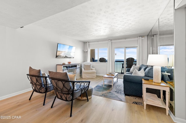 23223 Front Beach Rd Unit C1-502, Panama City Beach, FL 32413 - living area with a textured ceiling, light wood-style floors, and baseboards