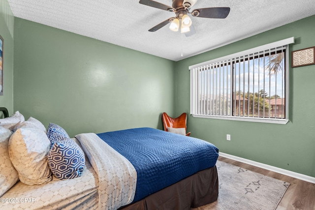 17620 Front Beach Rd Unit P2, Panama City Beach, FL 32413 - bedroom with wood finished floors, baseboards, a textured ceiling, and a ceiling fan