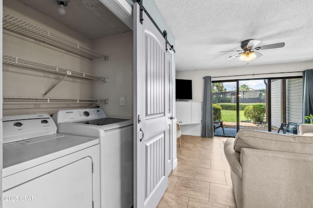 17620 Front Beach Rd Unit P2, Panama City Beach, FL 32413 - laundry room featuring a barn door, washer and clothes dryer, and ceiling fan