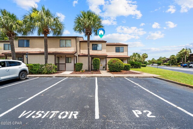 17620 Front Beach Rd Unit P2, Panama City Beach, FL 32413 - view of front of property with uncovered parking and stucco siding