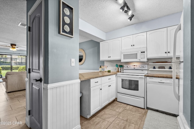 17620 Front Beach Rd Unit P2, Panama City Beach, FL 32413 - kitchen with white appliances, a textured ceiling, white cabinets, a ceiling fan, and backsplash