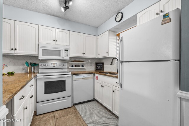 17620 Front Beach Rd Unit P2, Panama City Beach, FL 32413 - kitchen featuring white appliances, backsplash, a sink, white cabinets, and a textured ceiling