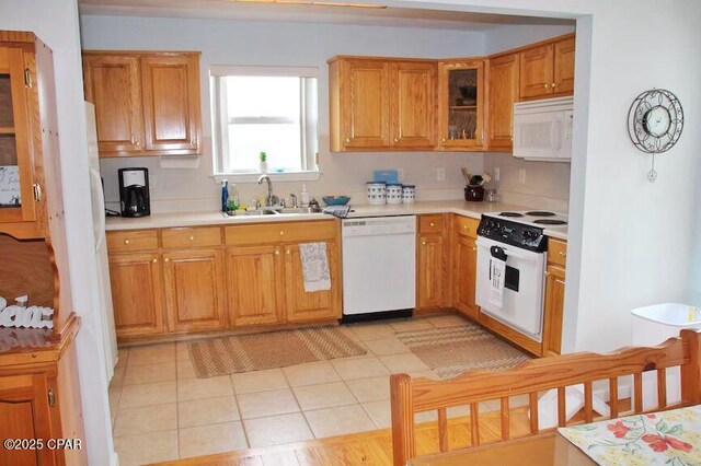 992 Hammond Lake Dr, Fountain, FL 32438 - kitchen featuring white appliances, light countertops, glass insert cabinets, and light tile patterned flooring