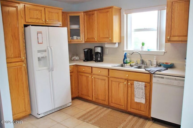 992 Hammond Lake Dr, Fountain, FL 32438 - kitchen with white appliances, light countertops, glass insert cabinets, brown cabinetry, and light tile patterned floors