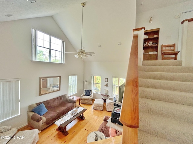 992 Hammond Lake Dr, Fountain, FL 32438 - living room with high vaulted ceiling, wood finished floors, healthy amount of natural light, a ceiling fan, and stairs
