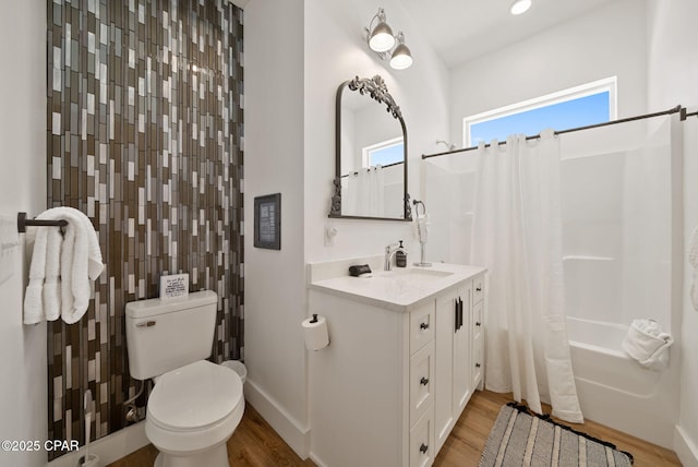 309 Tanaga St, Panama City Beach, FL 32413 - full bathroom with vanity, wood finished floors, and shower / bath combo with shower curtain