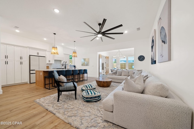 309 Tanaga St, Panama City Beach, FL 32413 - living area with light wood-style floors, recessed lighting, a ceiling fan, and a chandelier