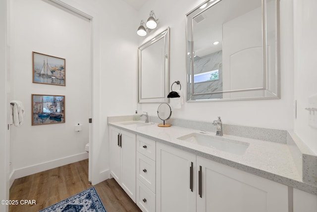 309 Tanaga St, Panama City Beach, FL 32413 - bathroom featuring double vanity and wood finished floors