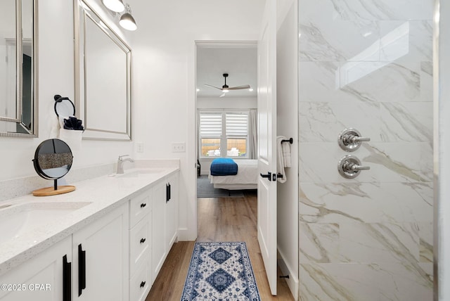 309 Tanaga St, Panama City Beach, FL 32413 - full bath featuring ensuite bath, double vanity, a marble finish shower, wood finished floors, and a ceiling fan