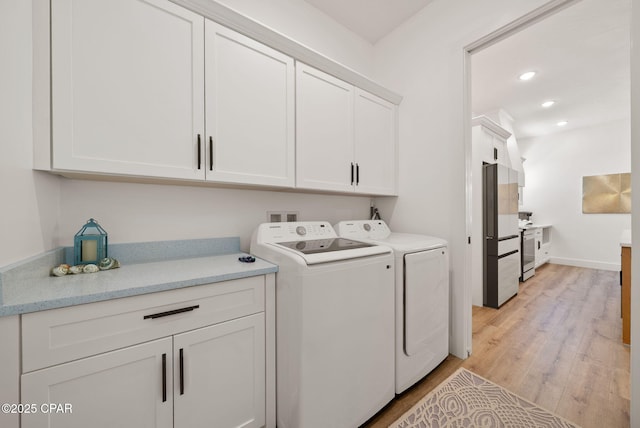 309 Tanaga St, Panama City Beach, FL 32413 - laundry area with cabinet space, washer and clothes dryer, light wood-style floors, and recessed lighting