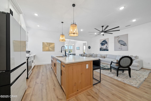 309 Tanaga St, Panama City Beach, FL 32413 - kitchen featuring stainless steel appliances, light wood-style floors, light countertops, a ceiling fan, and recessed lighting