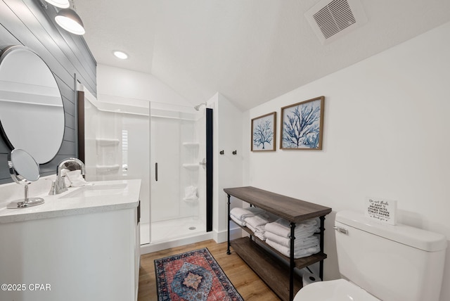 309 Tanaga St, Panama City Beach, FL 32413 - bathroom featuring a stall shower, wood finished floors, vanity, and lofted ceiling